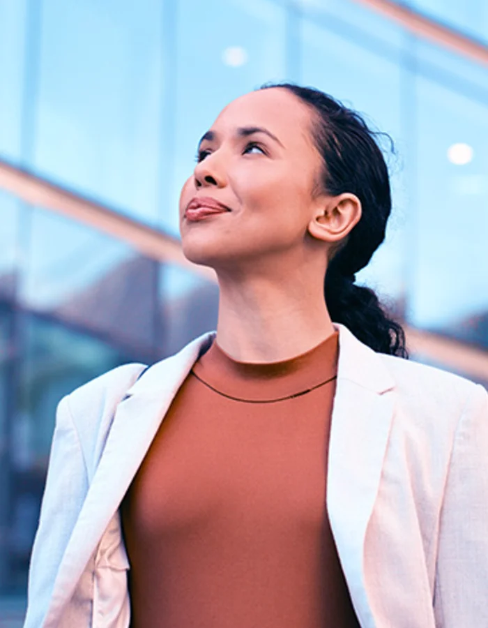 Young professional woman looking confident outside of an office building