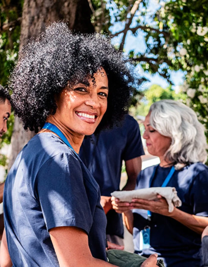 A woman smiling working at a volunteer event