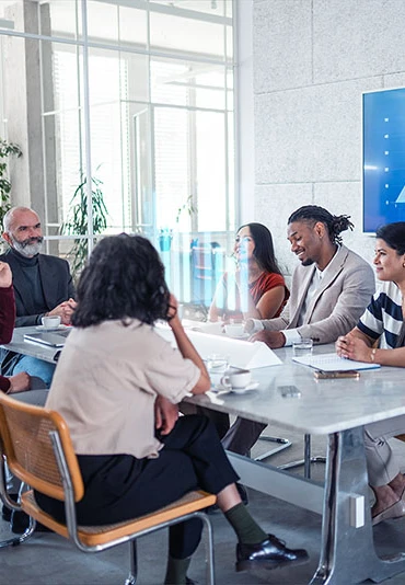 Six businesspeople meeting in a modern conference room