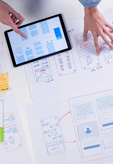 Two professionals marking up user experience flowcharts