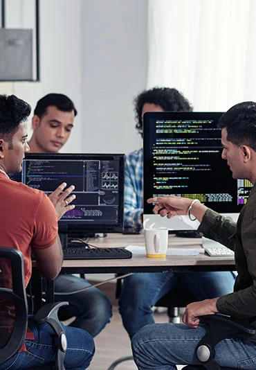 A team of coders collaborating in a shared office area