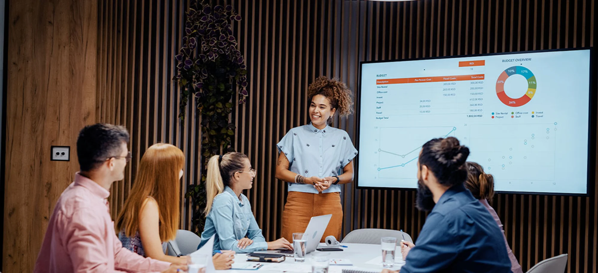 Young woman leading a team meeting in a modern conference room