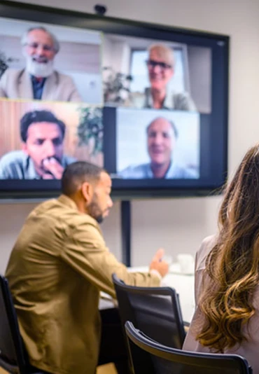 Young man sitting in a hybrid meeting