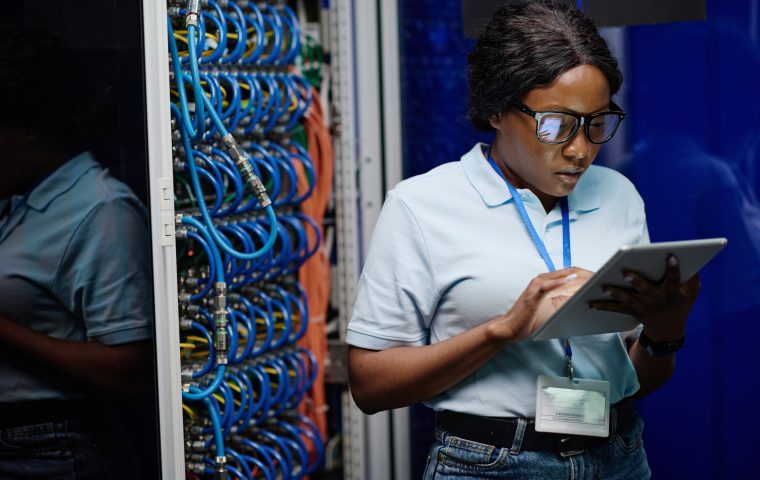 Female technician working on tablet in data center